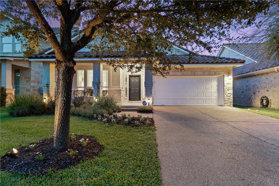 a front view of a house with a yard and garage