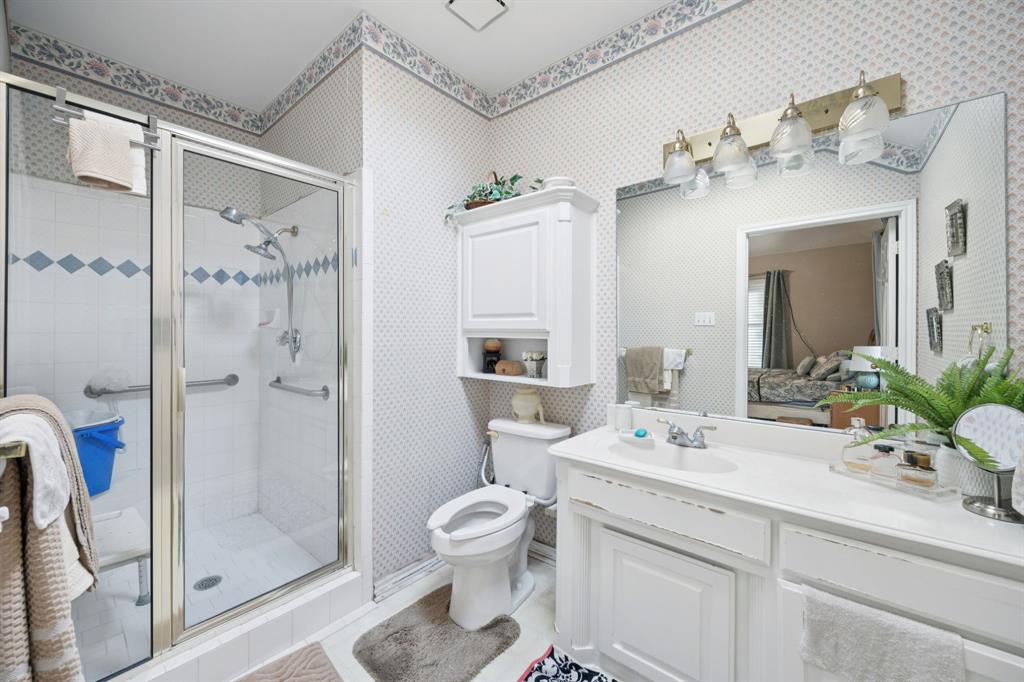 2901 Miles Way Bedford, TX 76021 - Photo 17 of 21 a bathroom with a sink a toilet and shower
