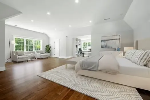 a bedroom with a large bed and a couch