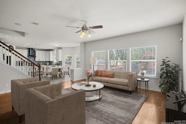 a living room with furniture and wooden floor