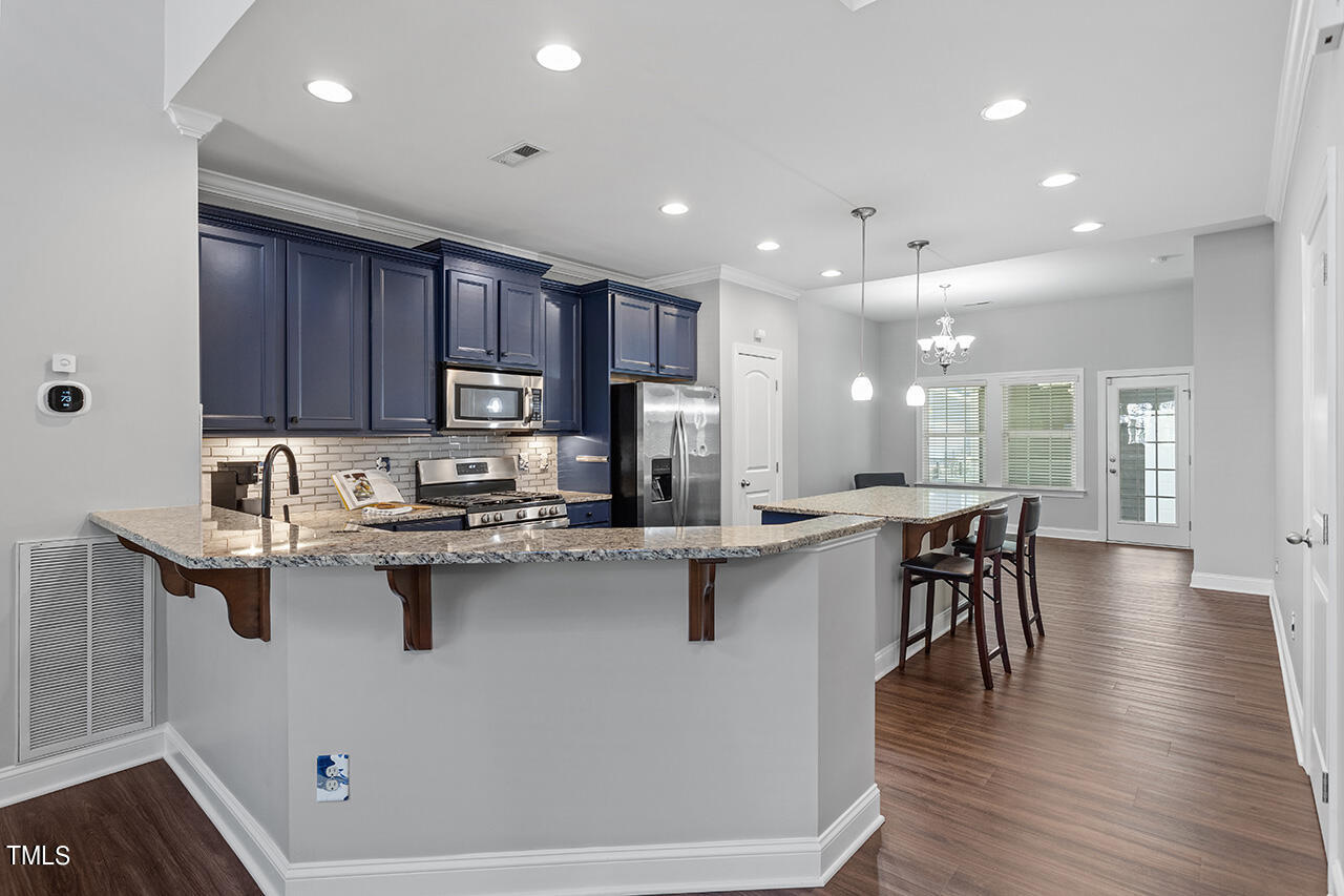 1337 Formal Garden Way Raleigh, NC 27603 - Photo 12 of 36 a kitchen with counter top space sink and center island