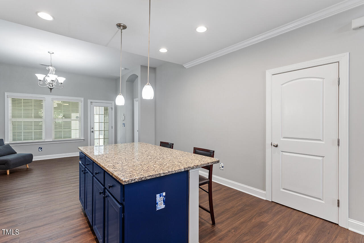 1337 Formal Garden Way Raleigh, NC 27603 - Photo 18 of 36 an open kitchen with a sink dishwasher and a dining table with wooden floor
