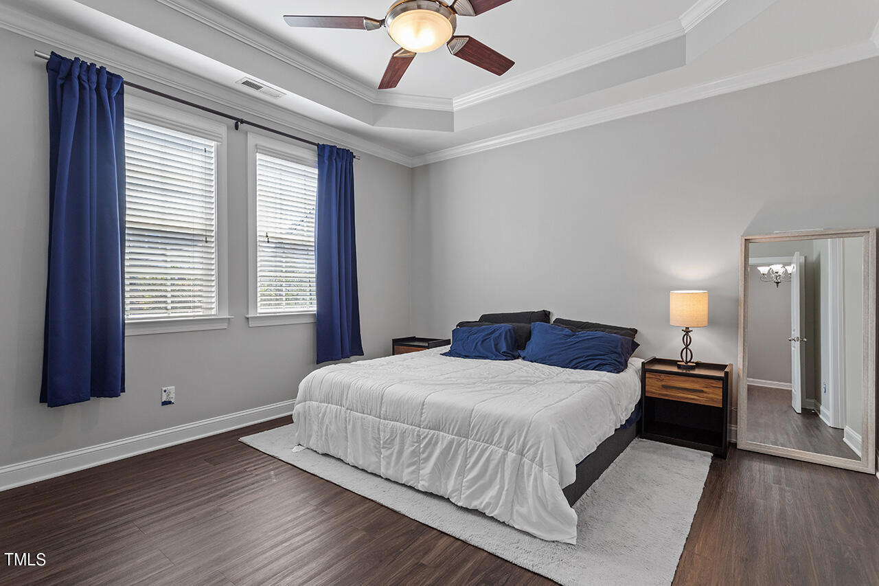 1337 Formal Garden Way Raleigh, NC 27603 - Photo 21 of 36 a bedroom with a large bed and a chandelier