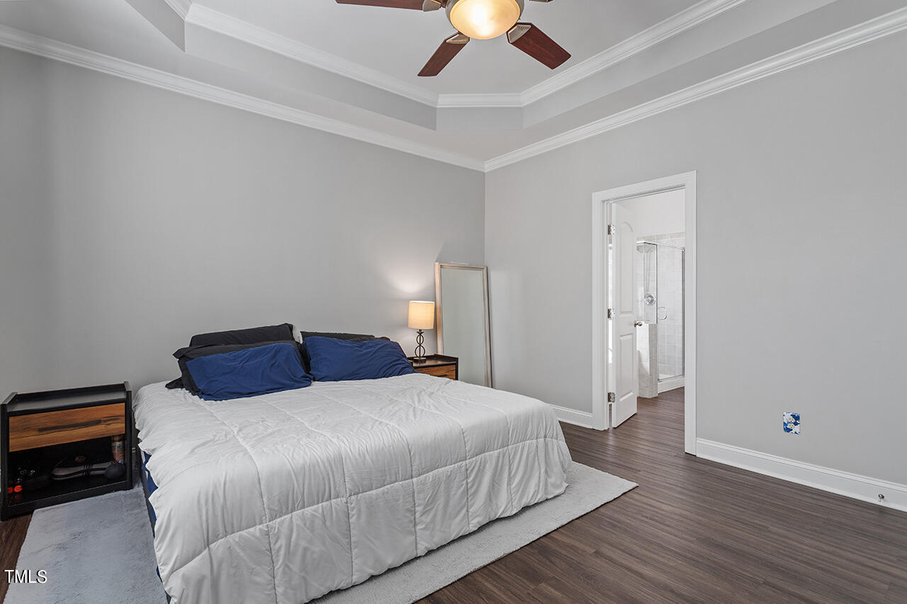 1337 Formal Garden Way Raleigh, NC 27603 - Photo 22 of 36 a bedroom with a bed and a chandelier