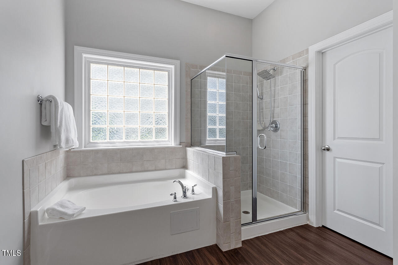 1337 Formal Garden Way Raleigh, NC 27603 - Photo 24 of 36 a bathroom with a bathtub and a shower
