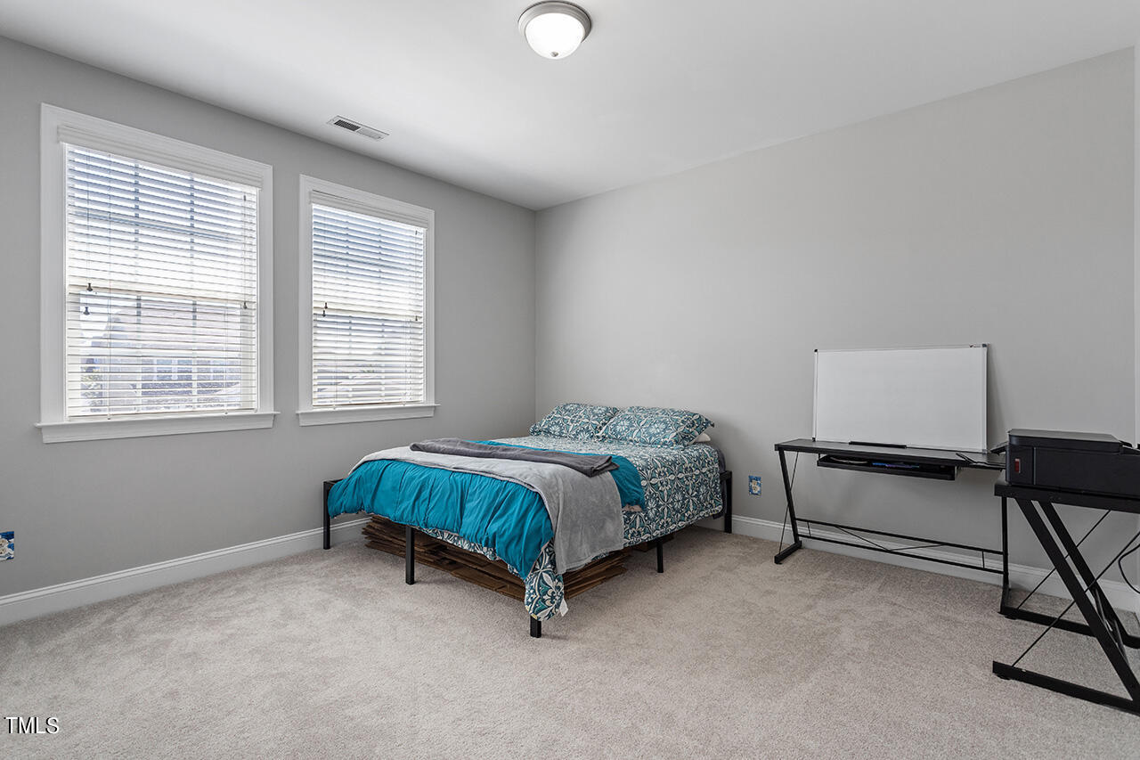 1337 Formal Garden Way Raleigh, NC 27603 - Photo 29 of 36 a bedroom with a bed chair and window