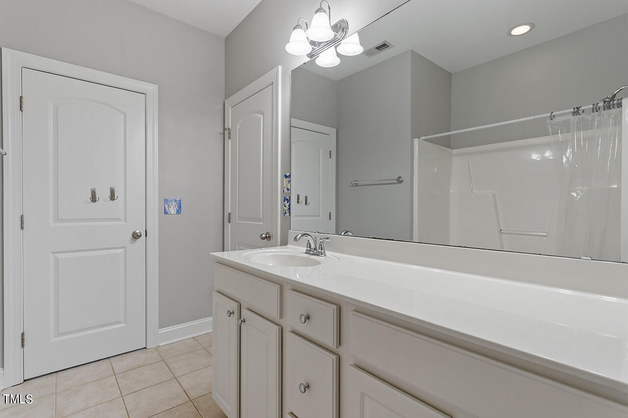 1337 Formal Garden Way Raleigh, NC 27603 - Photo 30 of 36 a bathroom with a sink vanity and a mirror