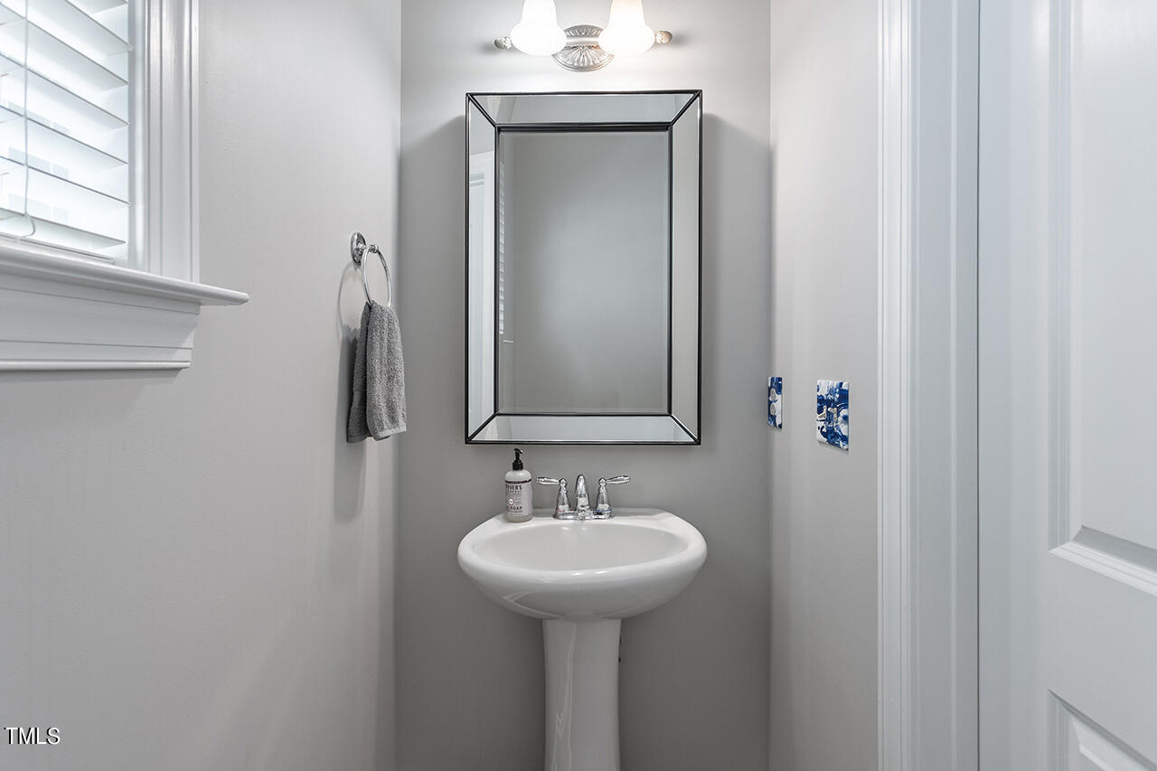 1337 Formal Garden Way Raleigh, NC 27603 - Photo 31 of 36 a bathroom with a sink and a mirror