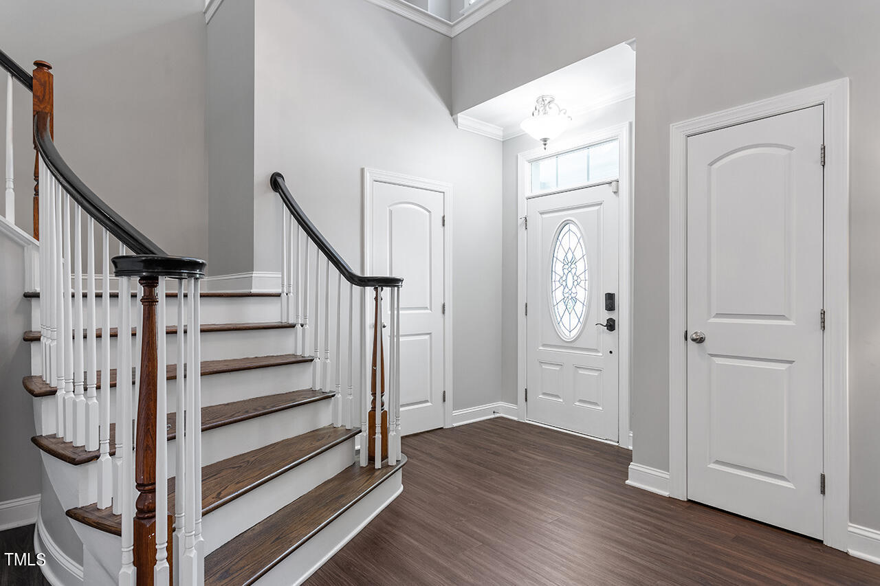 1337 Formal Garden Way Raleigh, NC 27603 - Photo 5 of 36 a view of a hallway with wooden floor and staircase