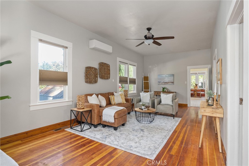 1805 Hemlock Street Chico, CA 95928 - Photo 2 of 61 a living room with furniture two windows and wooden floor