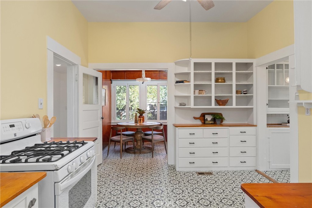 1805 Hemlock Street Chico, CA 95928 - Photo 22 of 61 a kitchen with a stove and a wooden cabinets