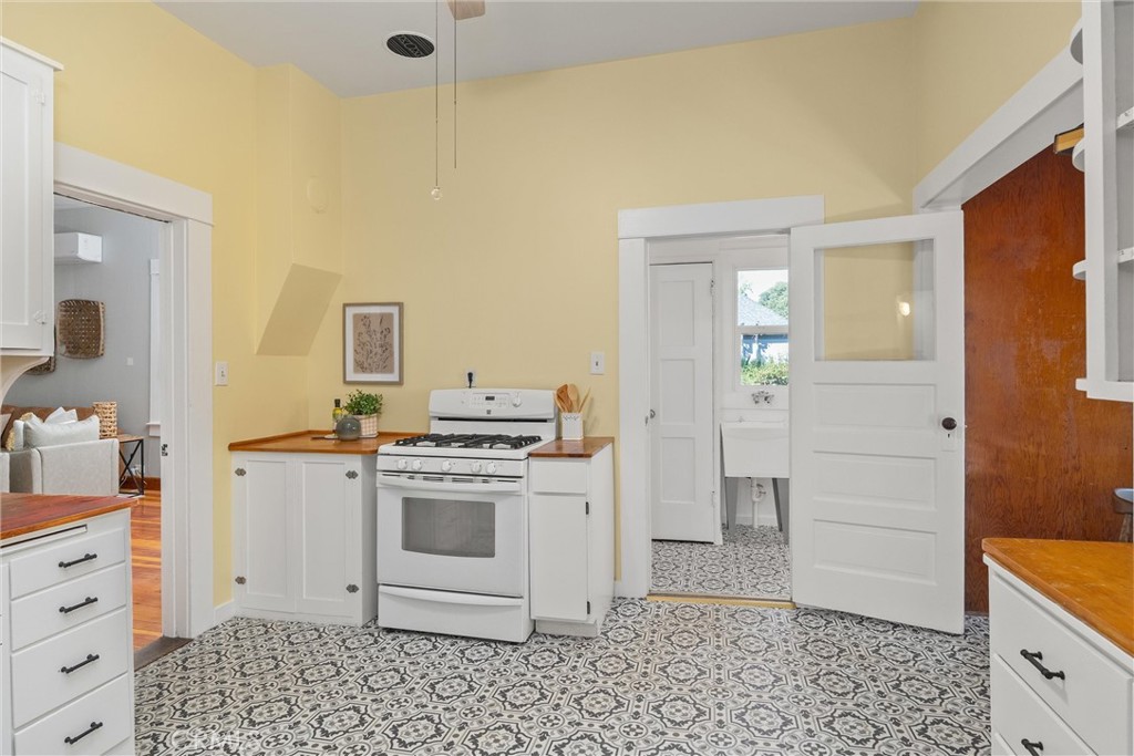 1805 Hemlock Street Chico, CA 95928 - Photo 25 of 61 a kitchen with a stove a sink and a refrigerator