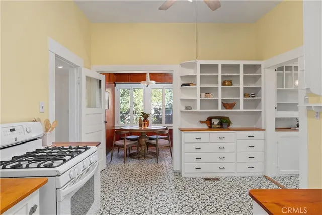 a kitchen with a stove and a wooden cabinets