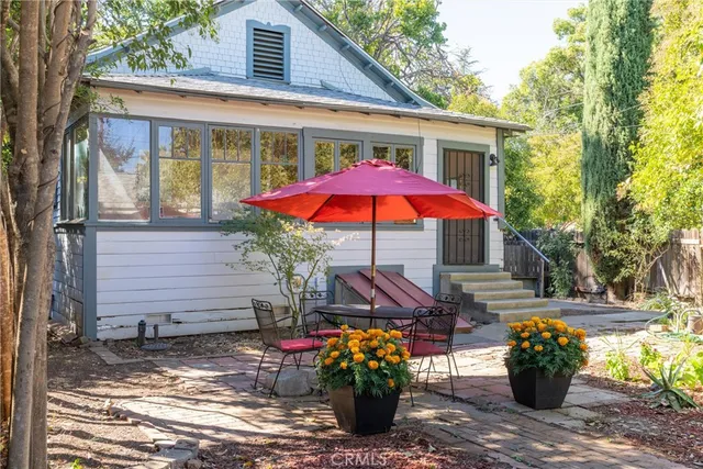 a front view of a house with plants