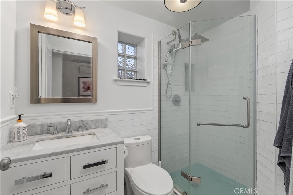 1805 Hemlock Street Chico, CA 95928 - Photo 58 of 61 a bathroom with a granite countertop sink toilet a mirror and shower