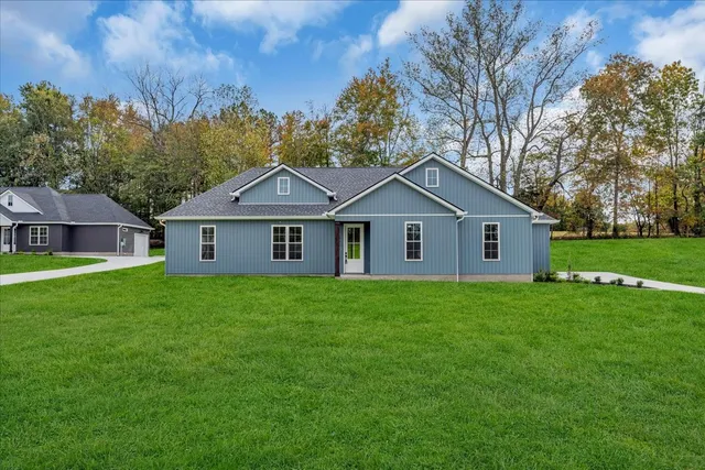 a view of a house and a yard with green space