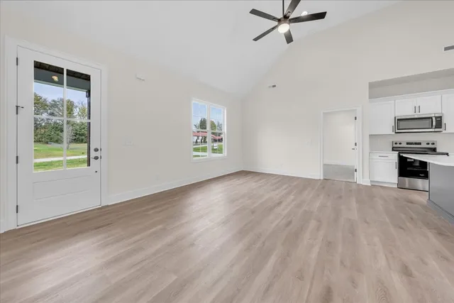 wooden floor in an empty room with a window