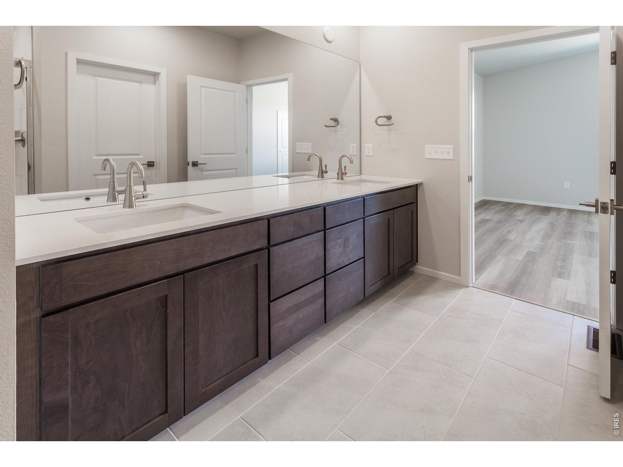 792 Chatter Road Windsor, CO 80550 - Photo 28 of 49 a bathroom with a double vanity sink and mirror