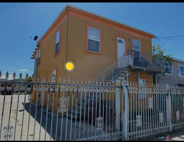 a view of a house with wooden fence
