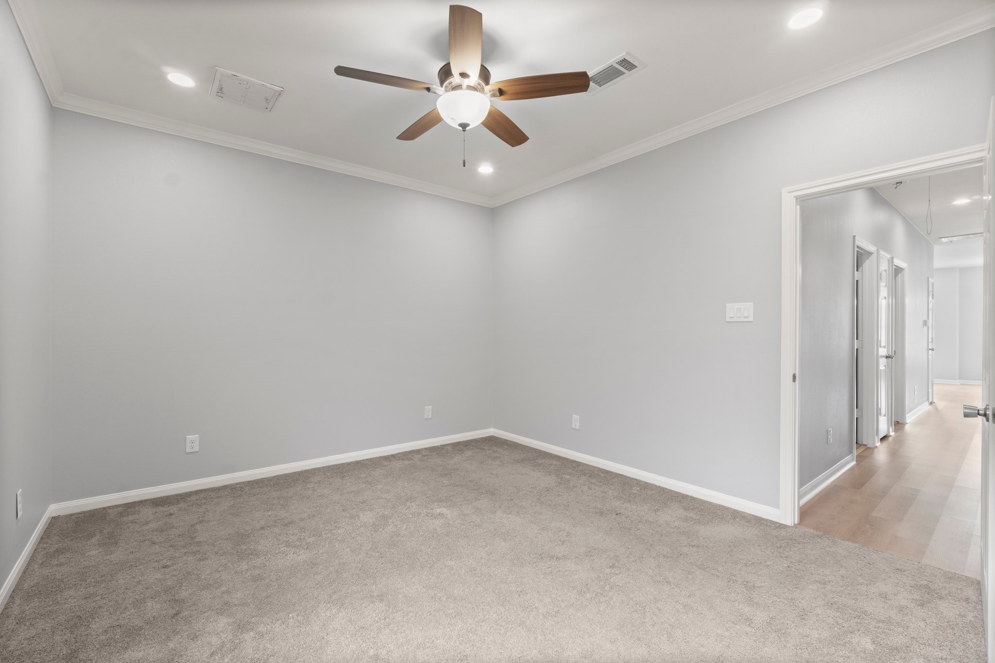 16866 West Hammon Montgomery, TX 77316 - Photo 18 of 21 wooden floor in an empty room with a ceiling fan