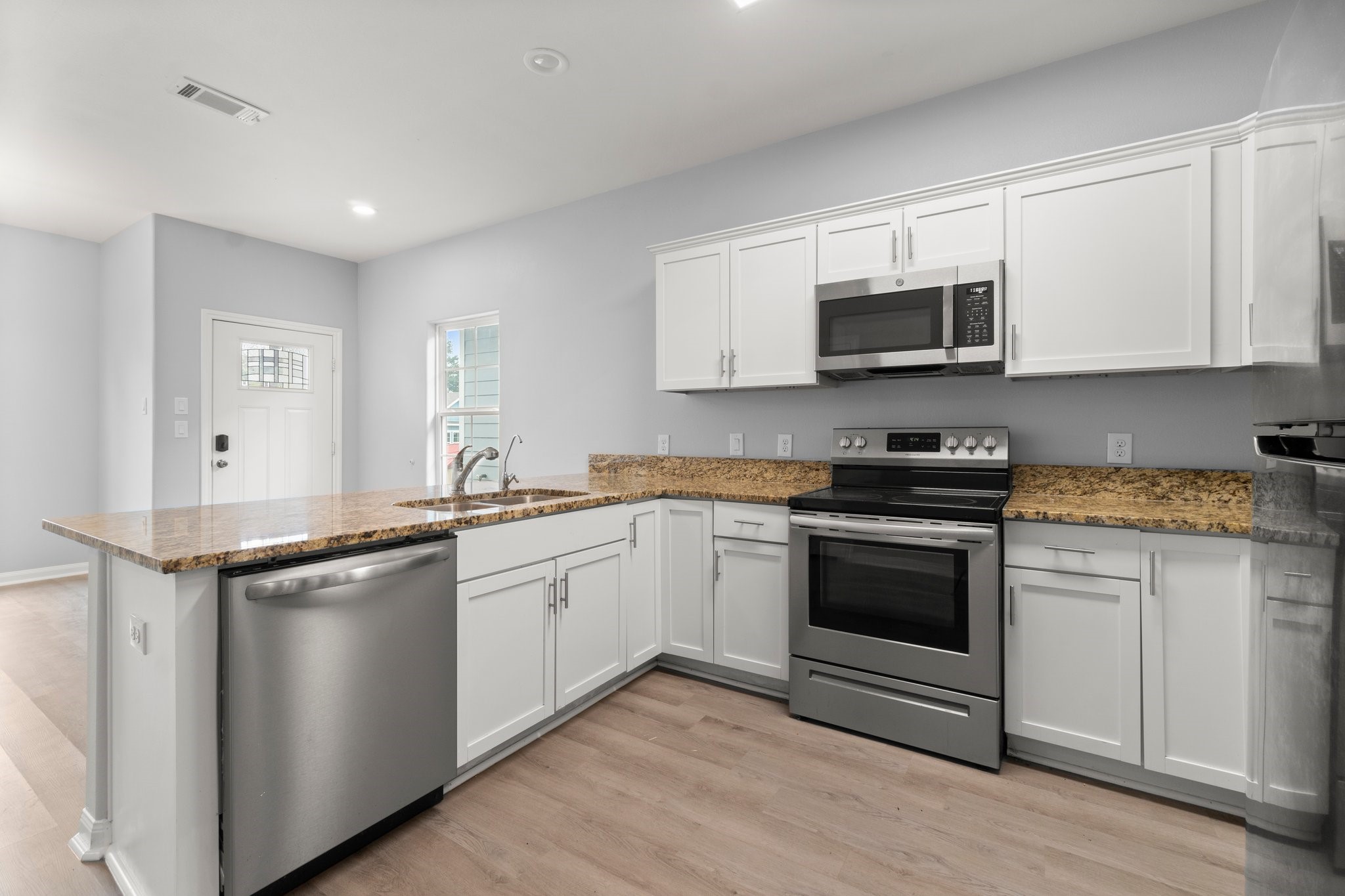 16866 West Hammon Montgomery, TX 77316 - Photo 8 of 21 a kitchen with stainless steel appliances granite countertop a sink stove and microwave