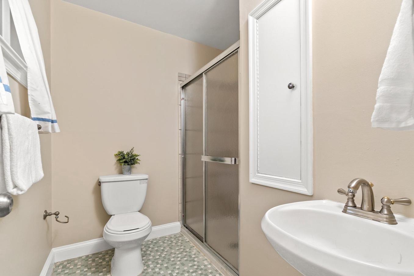 6505 Farley Street Springfield, VA 22152 - Photo 14 of 30 a bathroom with a toilet sink and shower
