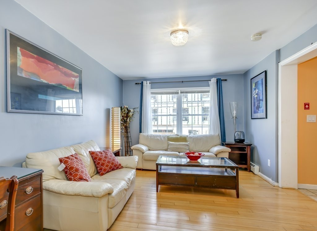 2-6 Guild Street, Unit 4 Boston, MA 02119 - Photo 1 of 20 a living room with furniture and a window