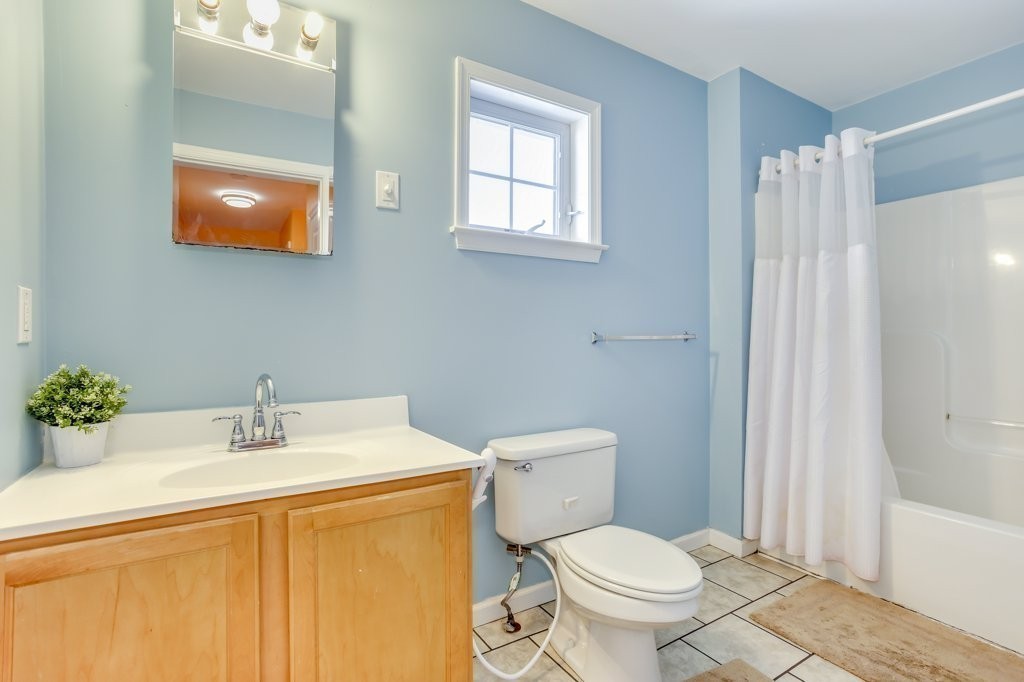 2-6 Guild Street, Unit 4 Boston, MA 02119 - Photo 16 of 20 a bathroom with a sink toilet and vanity
