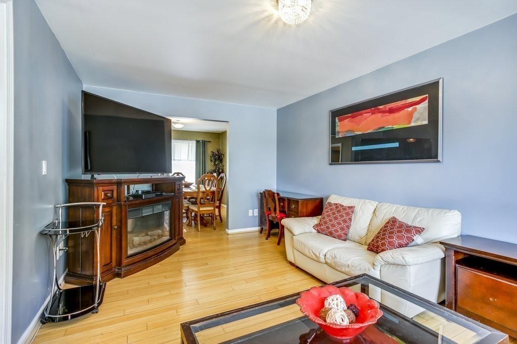 2-6 Guild Street, Unit 4 Boston, MA 02119 - Photo 3 of 20 a living room with furniture and a flat screen tv