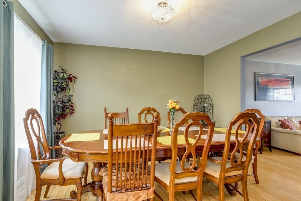 2-6 Guild Street, Unit 4 Boston, MA 02119 - Photo 8 of 20 a view of a dining room with furniture and wooden floor
