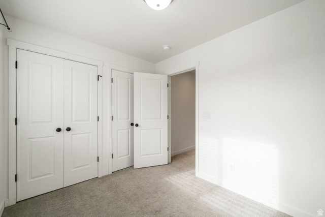 70 East Weekes Way Clearfield, UT 84015 - Photo 17 of 25 Unfurnished bedroom with carpet floors and a closet