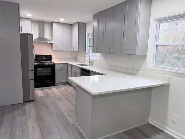 a kitchen with a refrigerator sink and stove