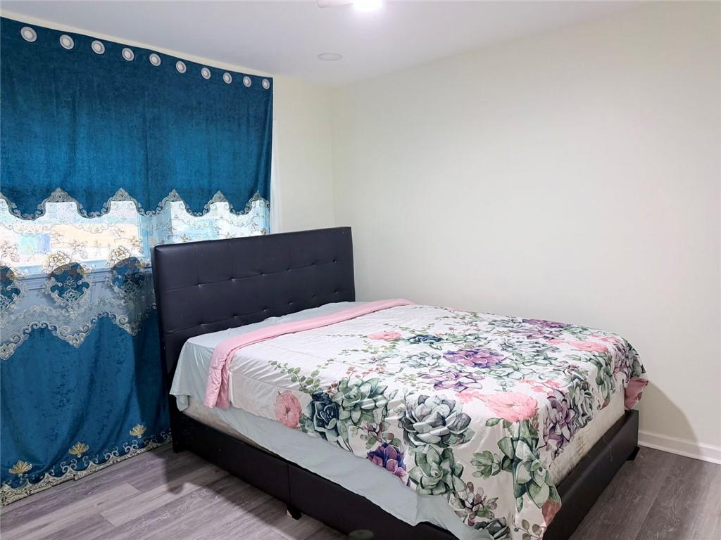 3878 Nielsen Court Clarkston, GA 30021 - Photo 18 of 26 a bedroom with bed and wooden floor