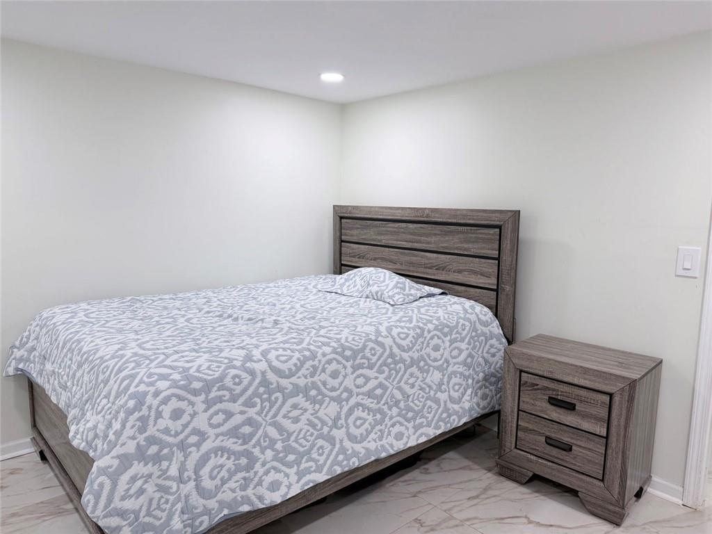 3878 Nielsen Court Clarkston, GA 30021 - Photo 19 of 26 a bedroom with a bed and a window