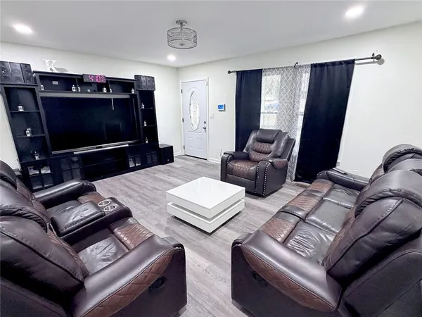 a living room with furniture and a flat screen tv