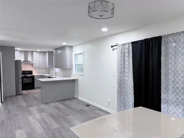 a kitchen with a refrigerator and a sink