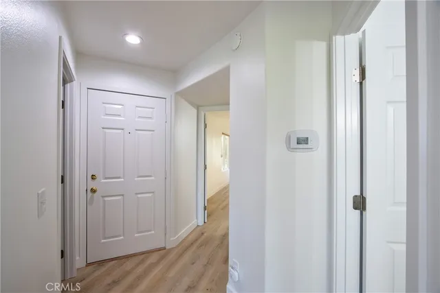 a view of a hallway with wooden floor