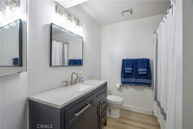 a bathroom with a toilet a sink and a mirror