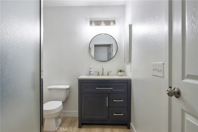 a bathroom with a toilet a sink and mirror