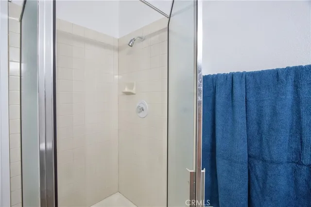 a bathroom with a shower and a sink
