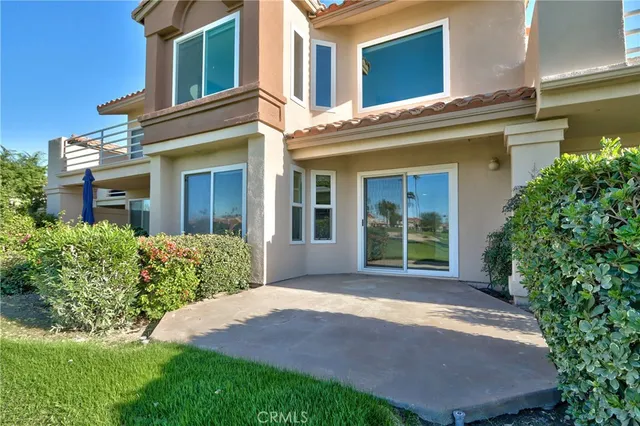 a front view of a building with a garden