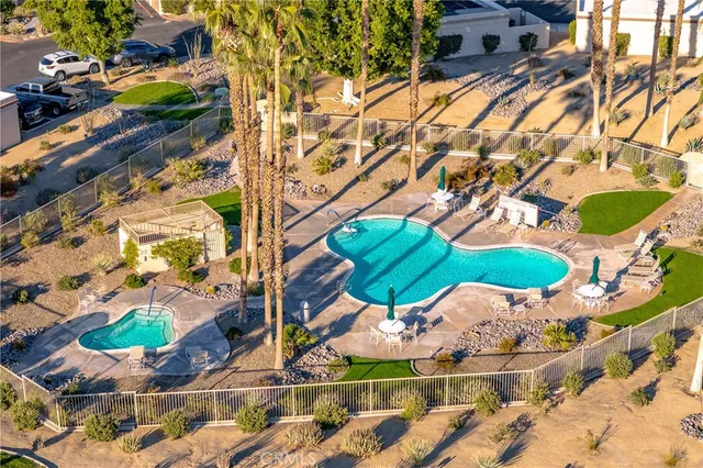 an aerial view of a house with a yard and outdoor seating