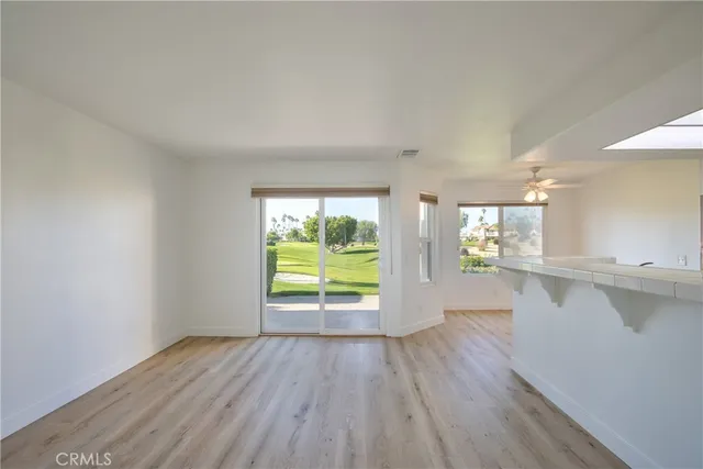 a view of room with window and wooden floor