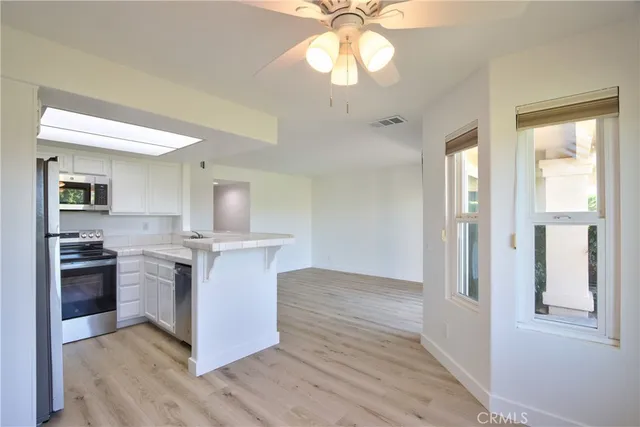 a kitchen with stainless steel appliances granite countertop a stove and a refrigerator
