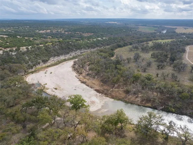a view of a dry yard with wooden fence