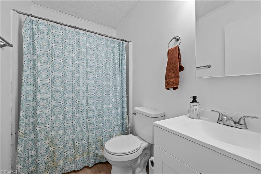 2036 Willow Road Greensboro, NC 27406 - Photo 18 of 19 Hall bath conveniently located close to two of the three bedrooms.