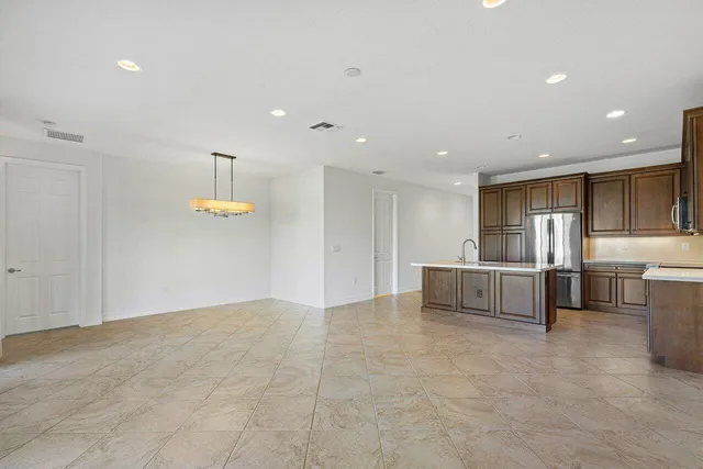 a view of kitchen with furniture and refrigerator