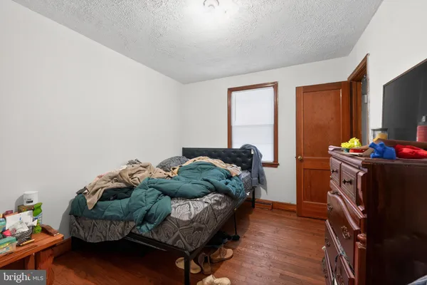 a bedroom with furniture and a flat screen tv