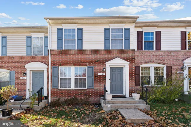a front view of a house with a yard and outdoor seating