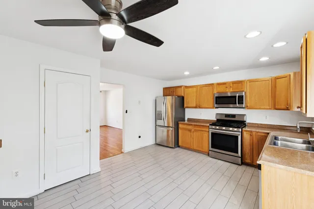 a kitchen with stainless steel appliances granite countertop a stove and a refrigerator